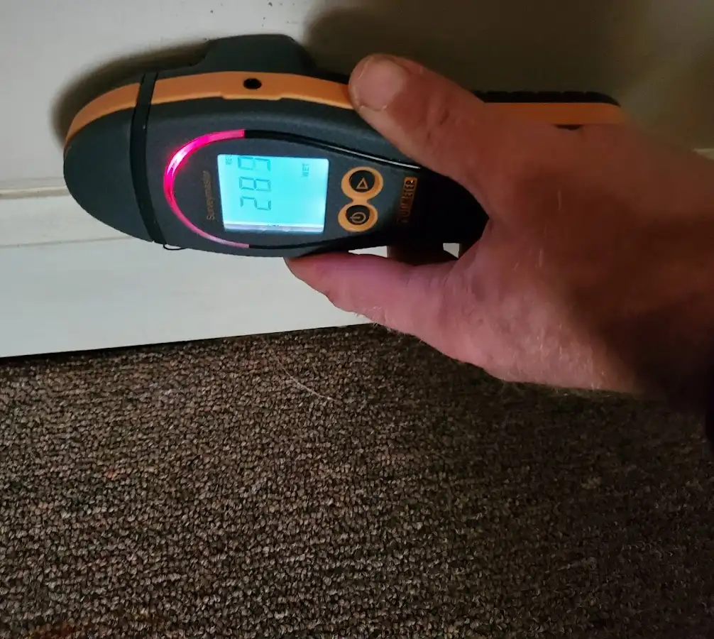 Moisture detection at baseboard during Storm Damage Restoration in Somerton